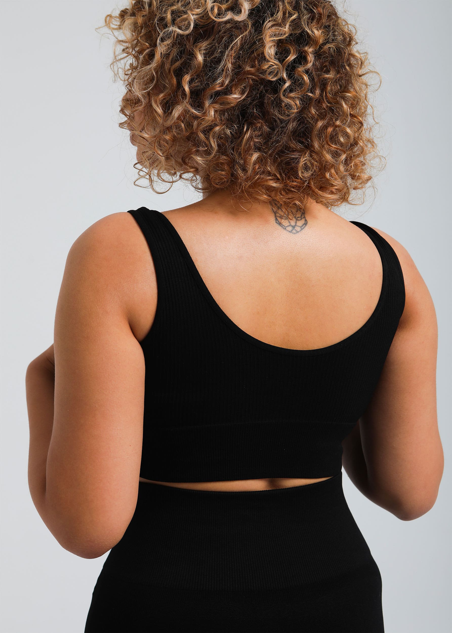 Close-up of ribbed fabric and support band on graphite black bra