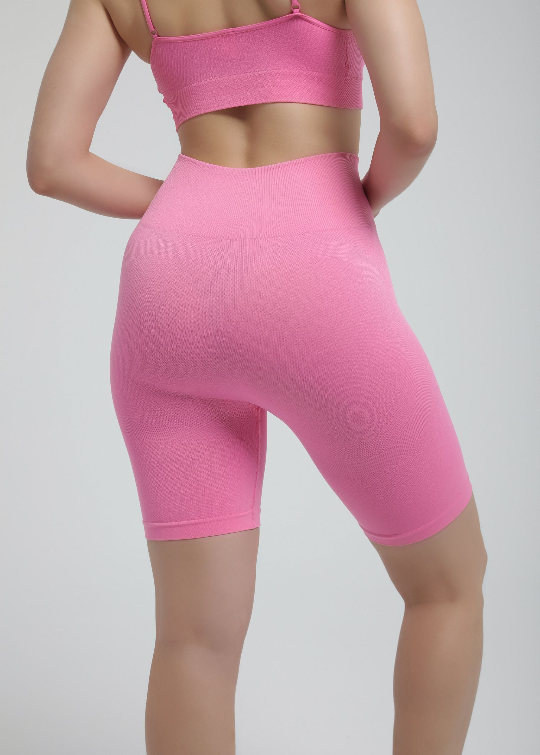Second Skin high-waist sculpting biker short in rose pink, back view highlighting seamless contour