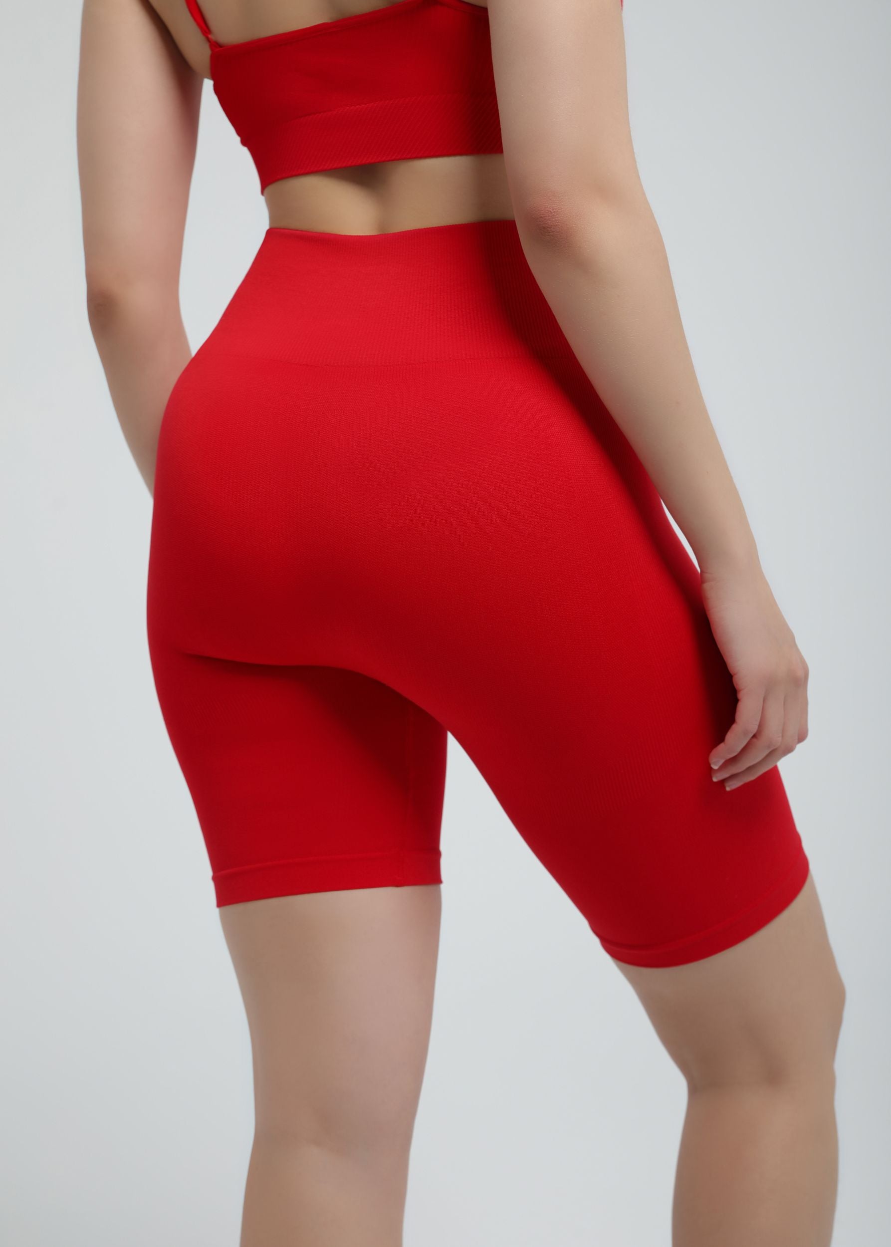 Second Skin high-waist sculpting biker short in true red, back view showing seamless design
