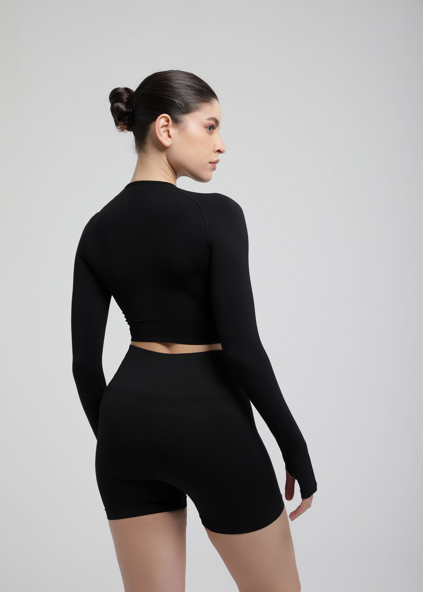 Second Skin long sleeve sculpting crop top in Black, back view highlighting seamless finish