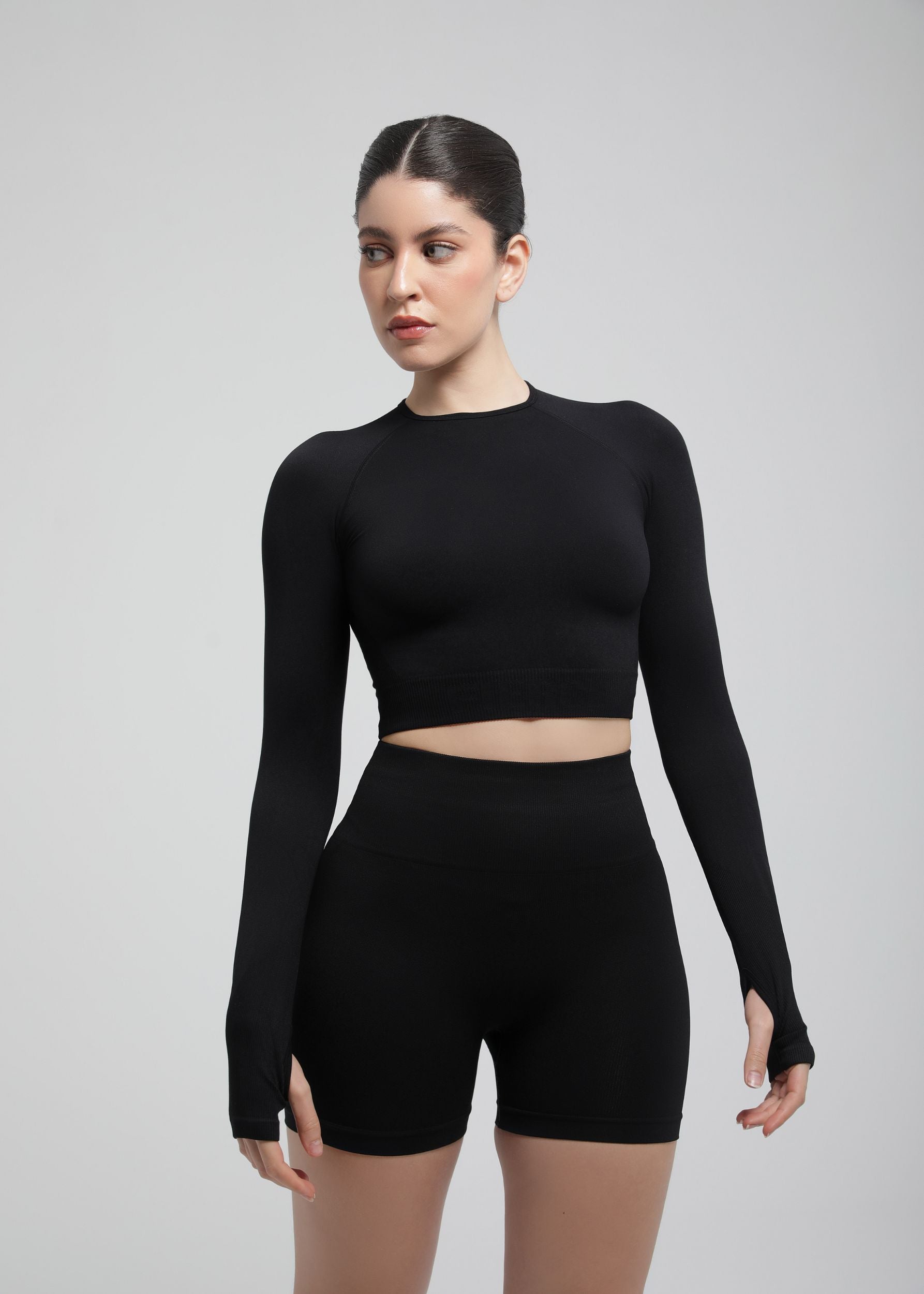 Second Skin long sleeve sculpting crop top in Black, front view on model