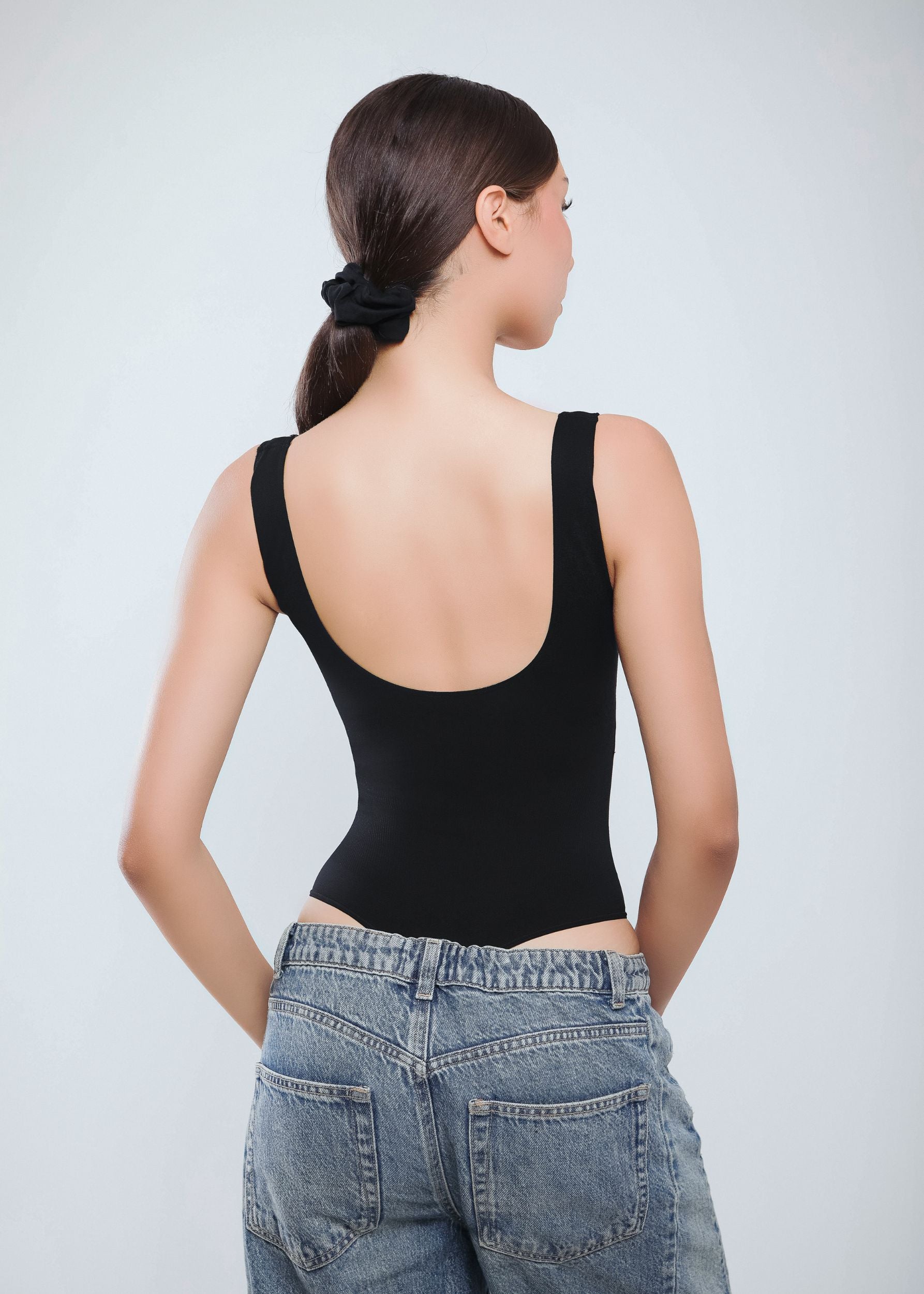 Second Skin Sculpting Thong Bodysuit in Graphite Black, worn back view