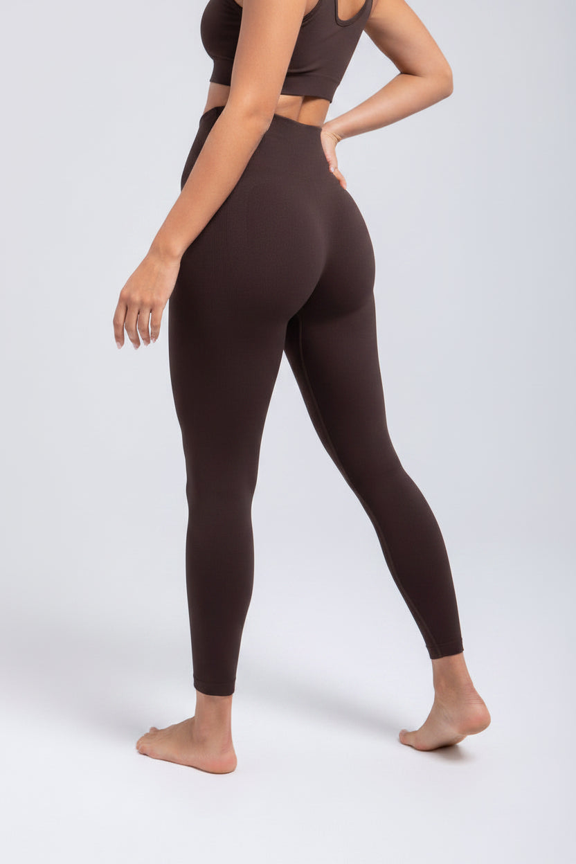 Brown leggings worn by a person on a white background