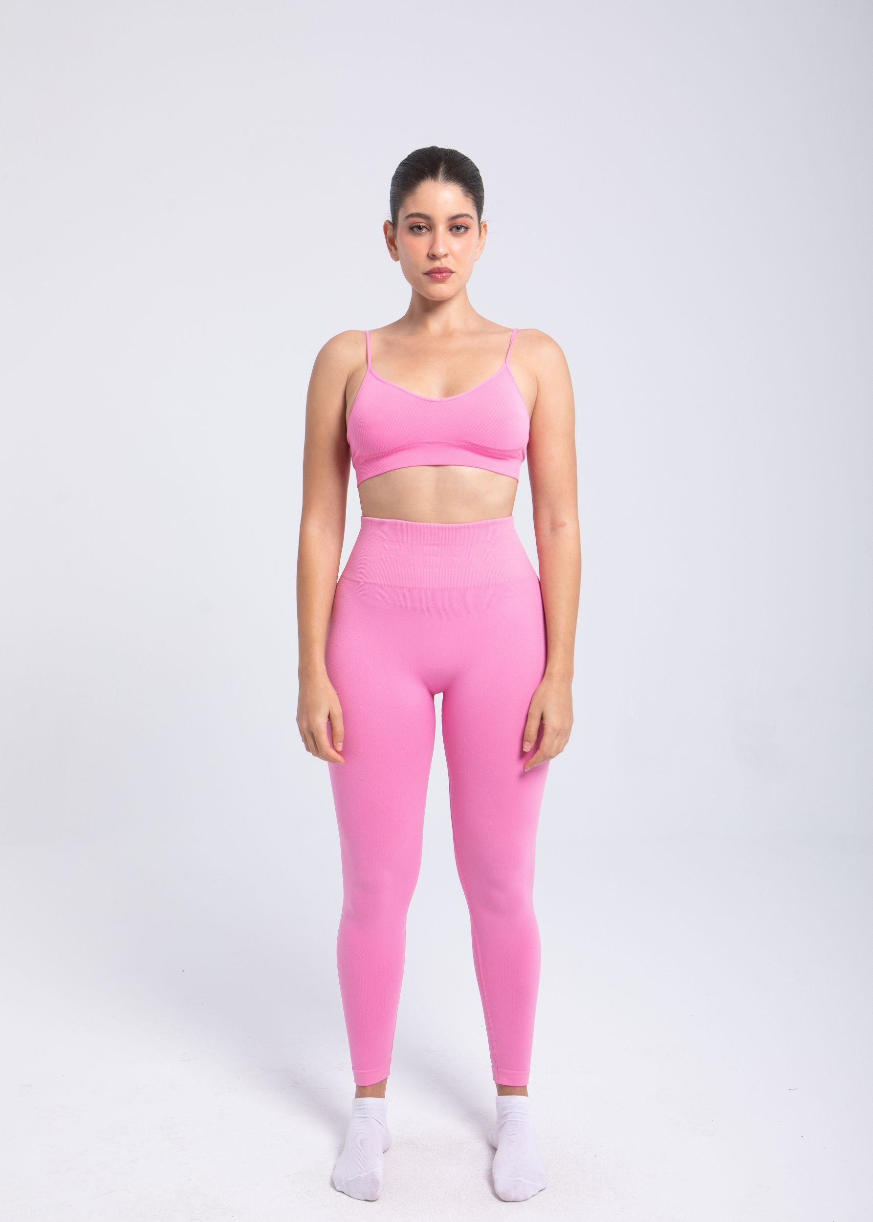 Model wearing Second Skin Essential Sculpting Bralette in pink, full-body studio view