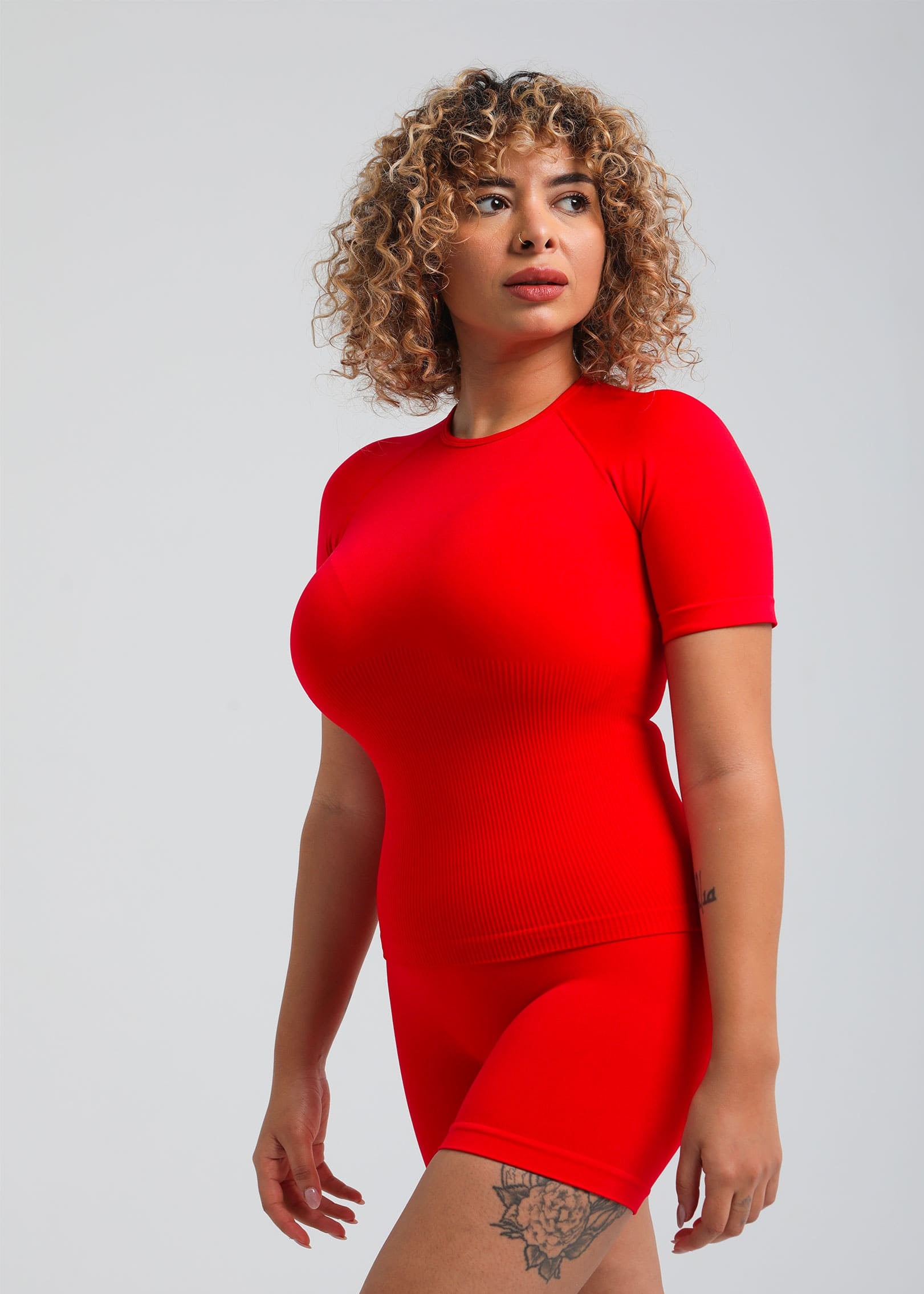 Second Skin Essential Sculpting T-Shirt in True Red, side profile emphasizing waist shaping
