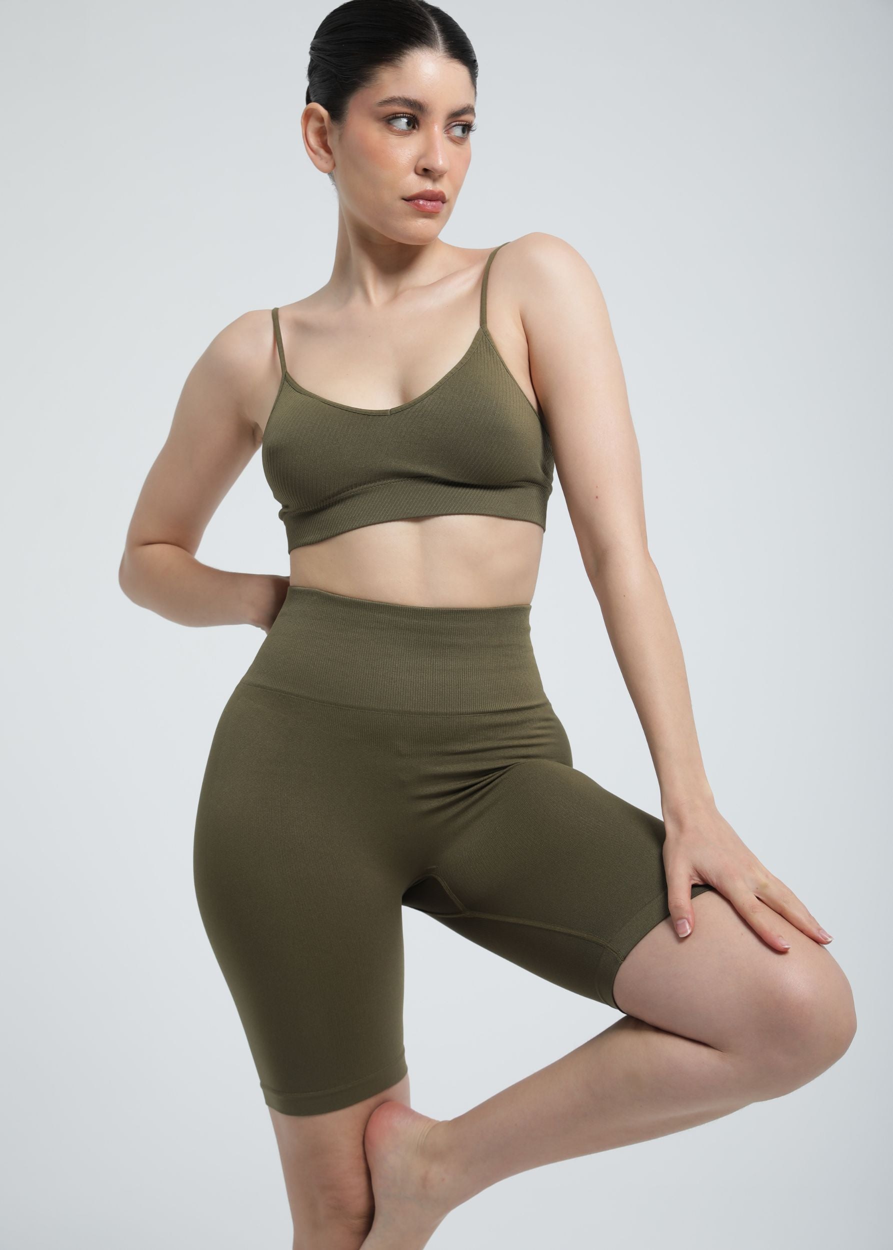 Olive khaki Second Skin biker short featuring sculpting waistband and breathable knit texture.

Second Skin Essential Sculpting Bralette in Olive Khaki, complete activewear look