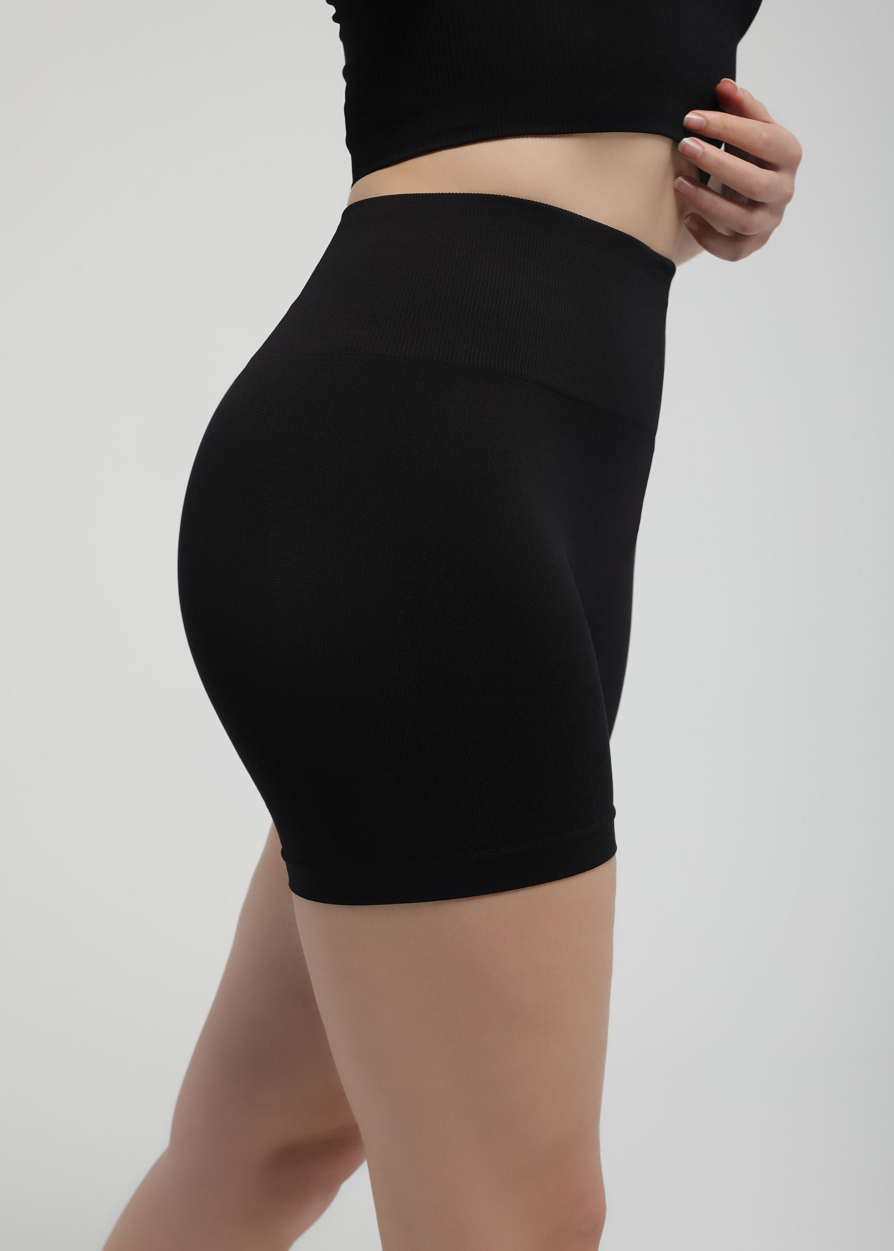 Side view of black second-skin sculpting shorts with contoured fit
