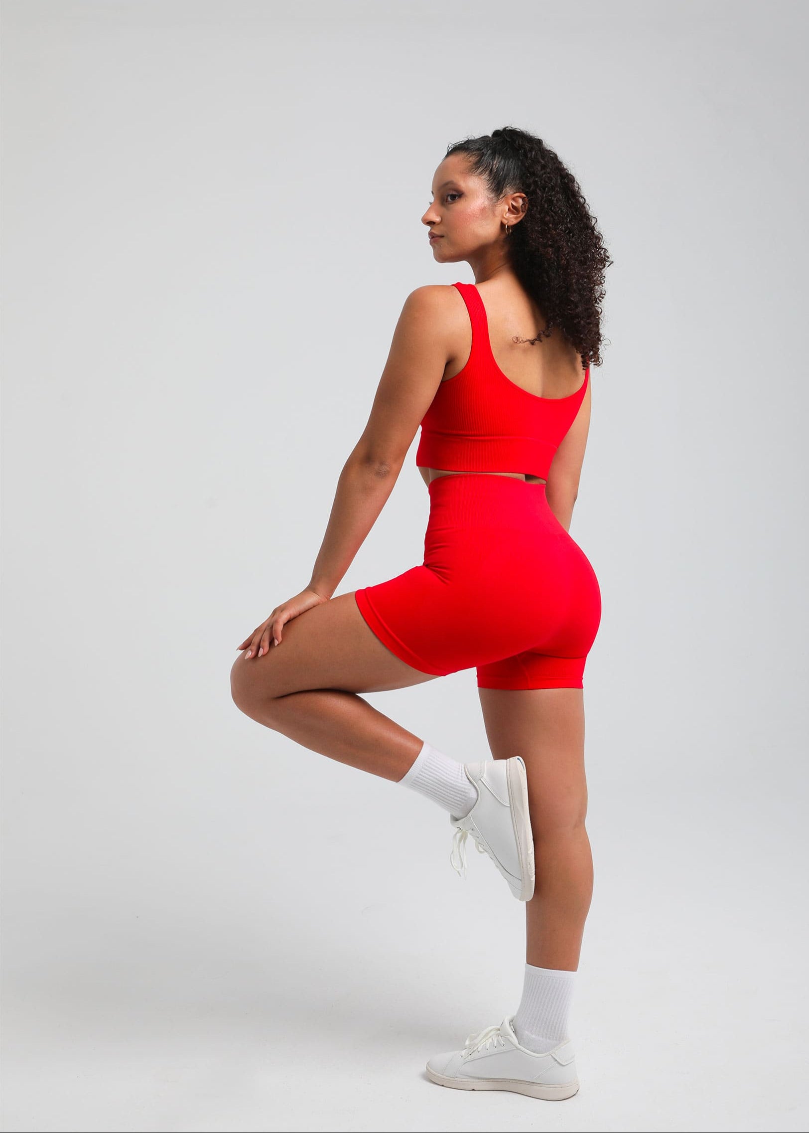 True Red high-waist sculpting shorts with seamless compression, side pose