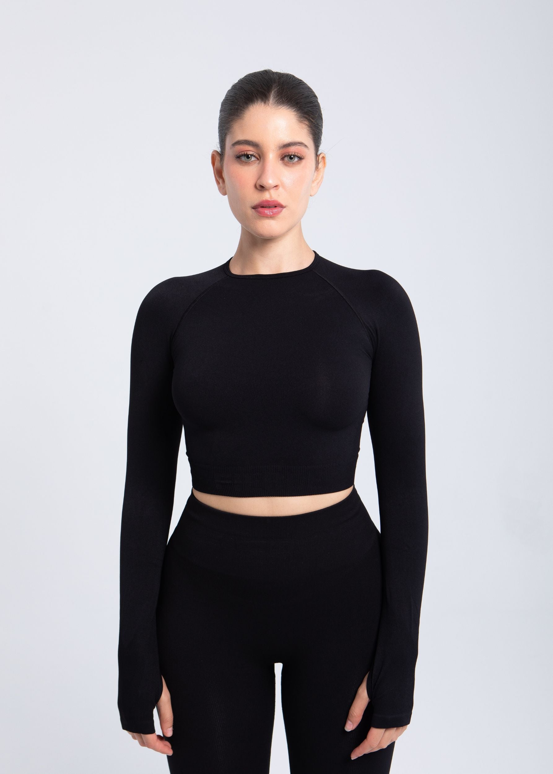 Second Skin long sleeve sculpting crop top in Black, front view on model