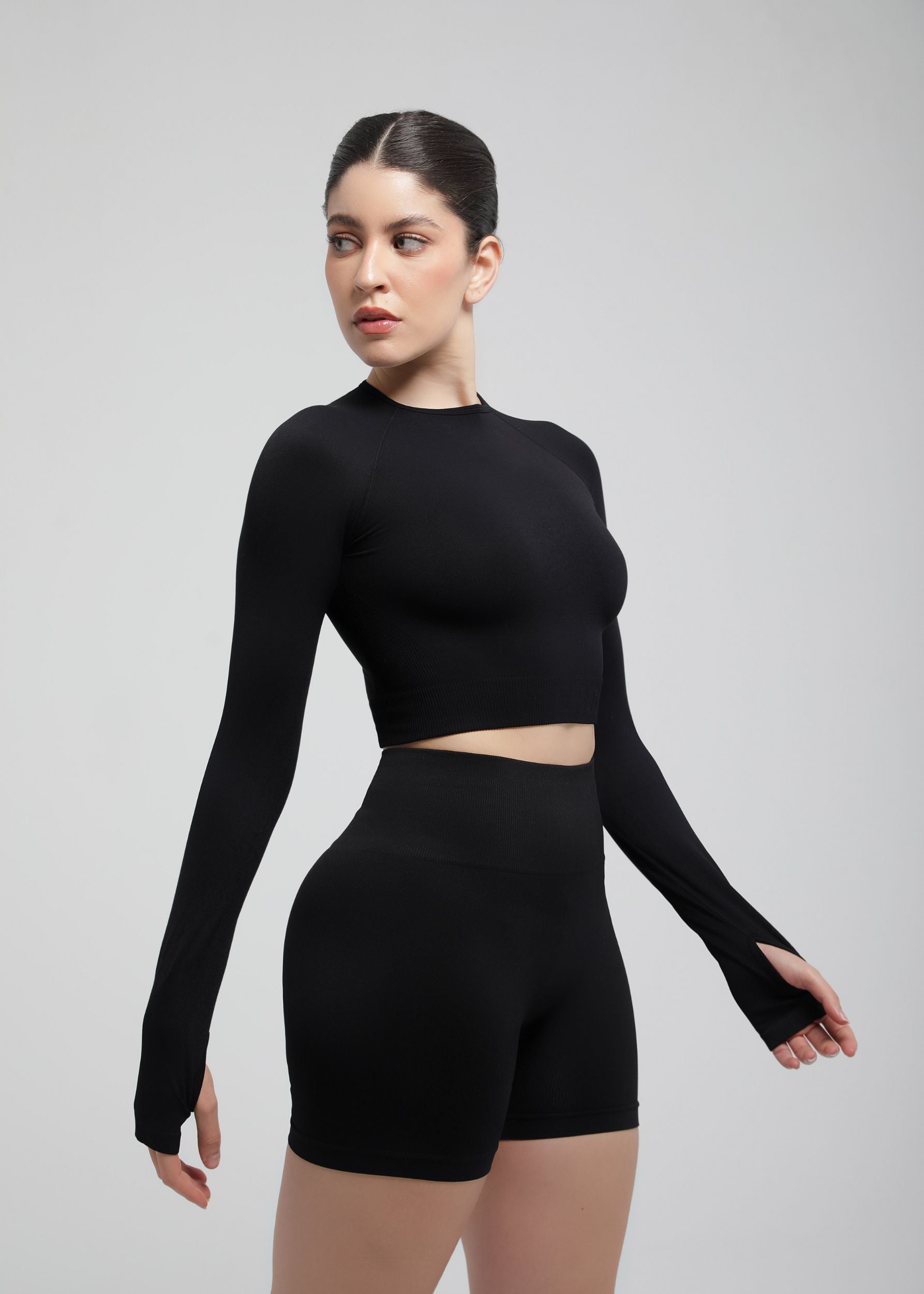 Second Skin long sleeve sculpting crop top in Black, side profile showing cropped length
