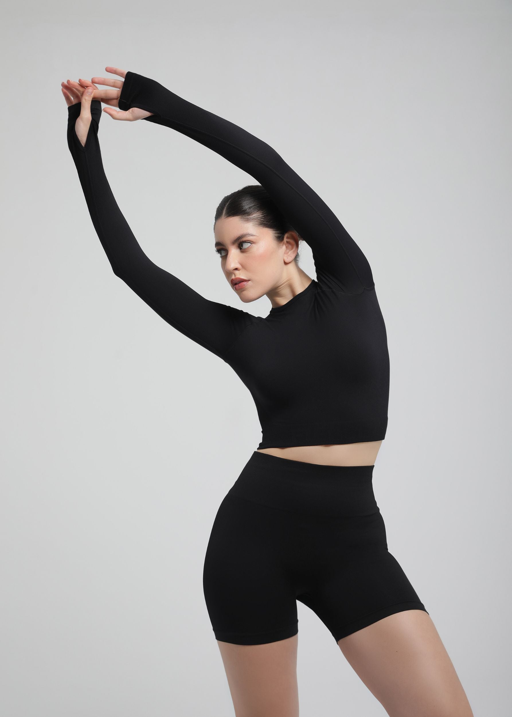 Second Skin long sleeve sculpting crop top in Black, close-up of sleeve and fabric texture
