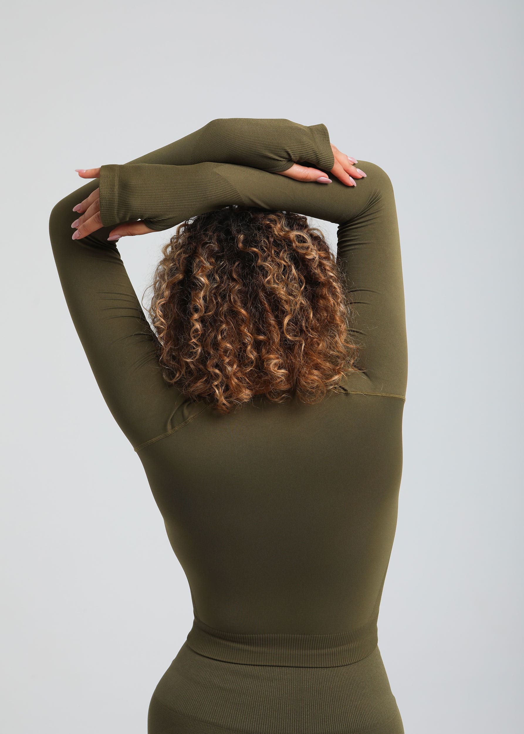 Second Skin long sleeve sculpting crop top in Olive, back view with smooth seamless construction