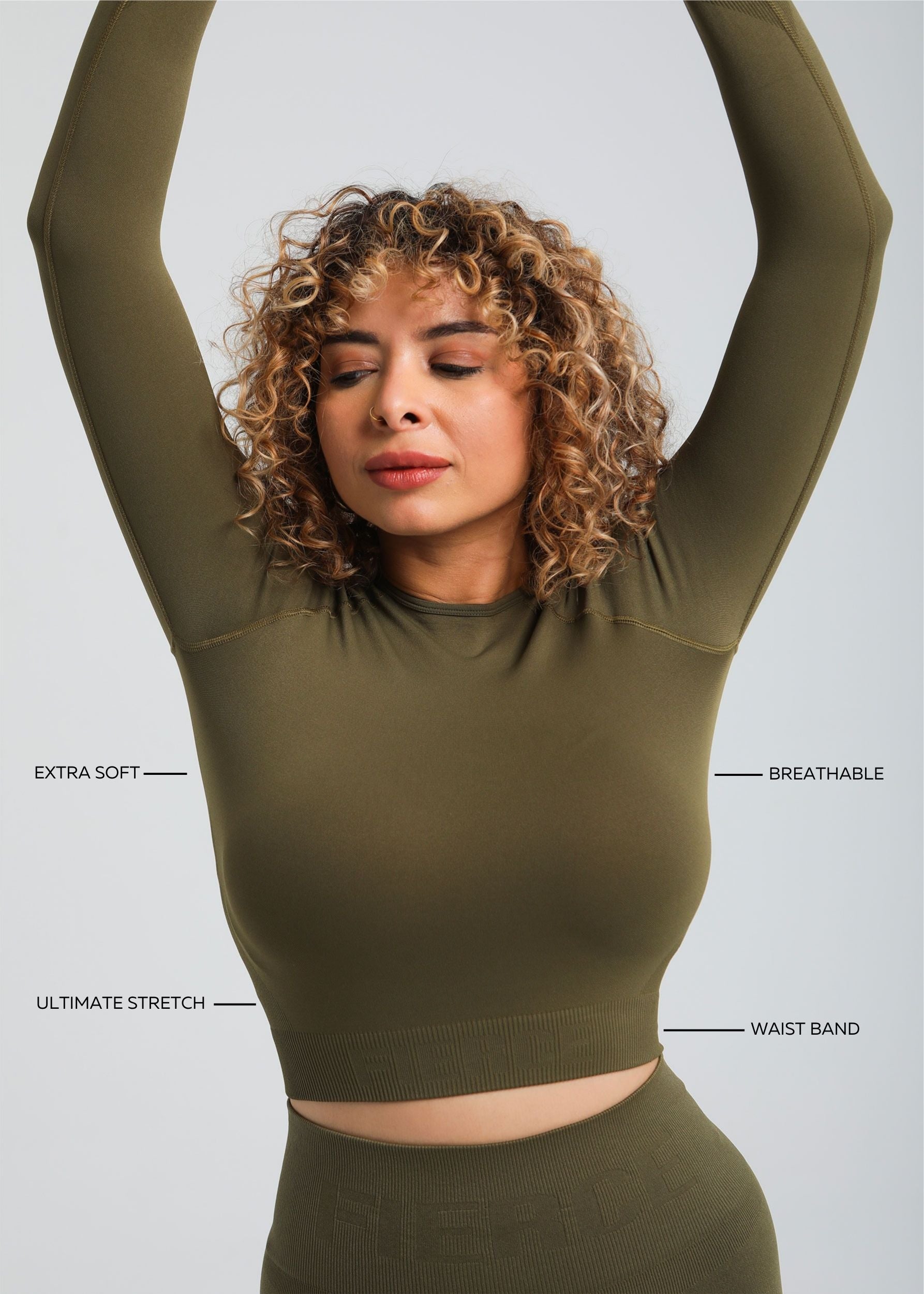 Second Skin long sleeve sculpting crop top in Olive, styling pose showing stretch and movement