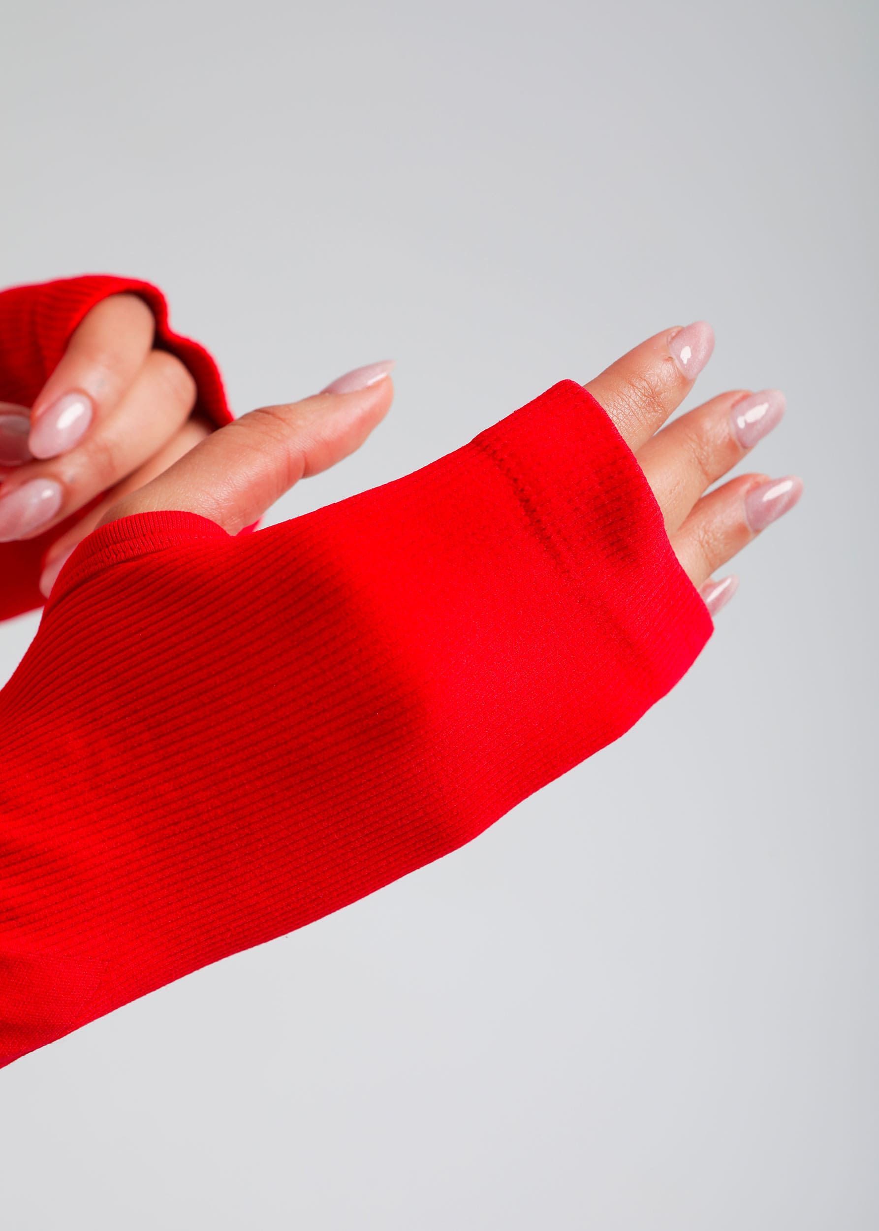 Second Skin long sleeve sculpting crop top in True Red, close-up of sleeve and fabric texture