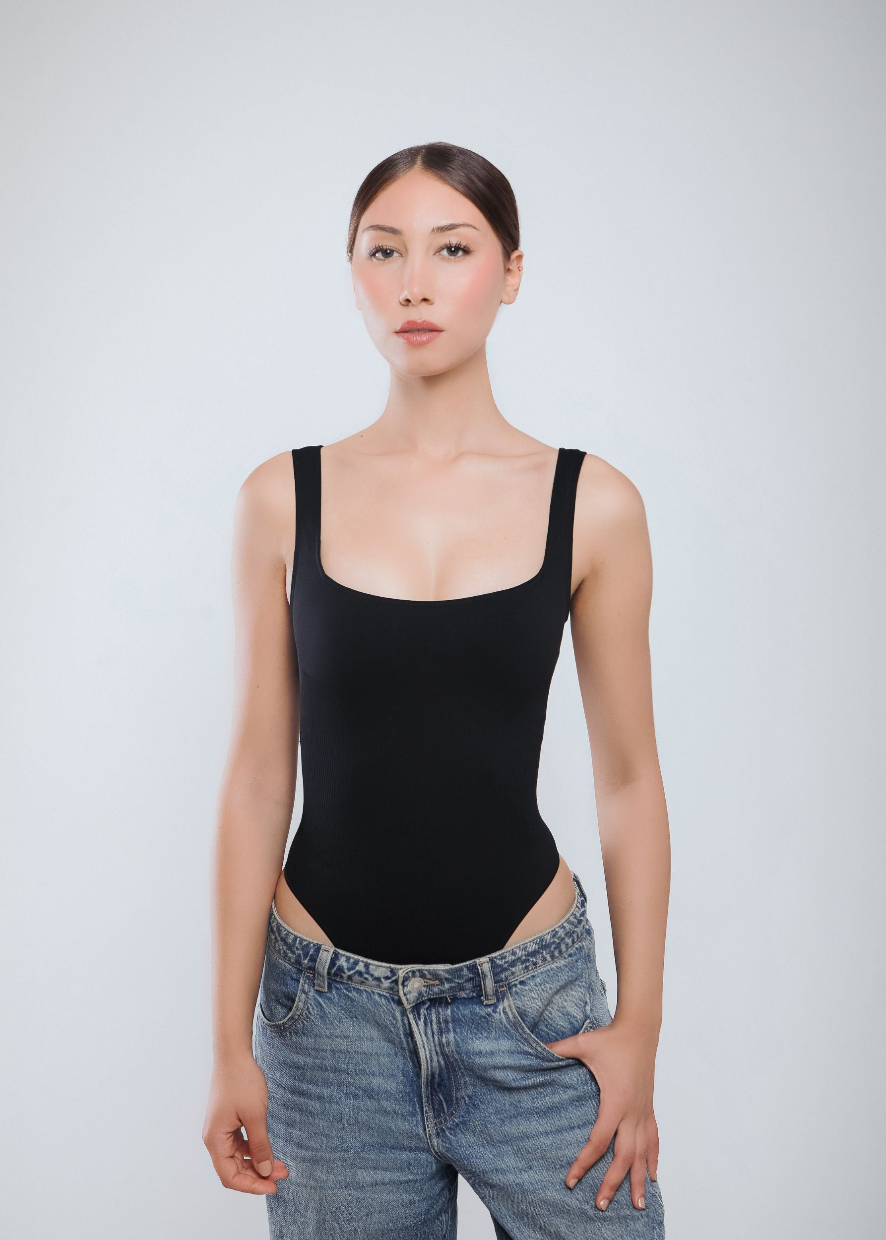 Second Skin Sculpting Thong Bodysuit in Graphite Black, worn front close-up