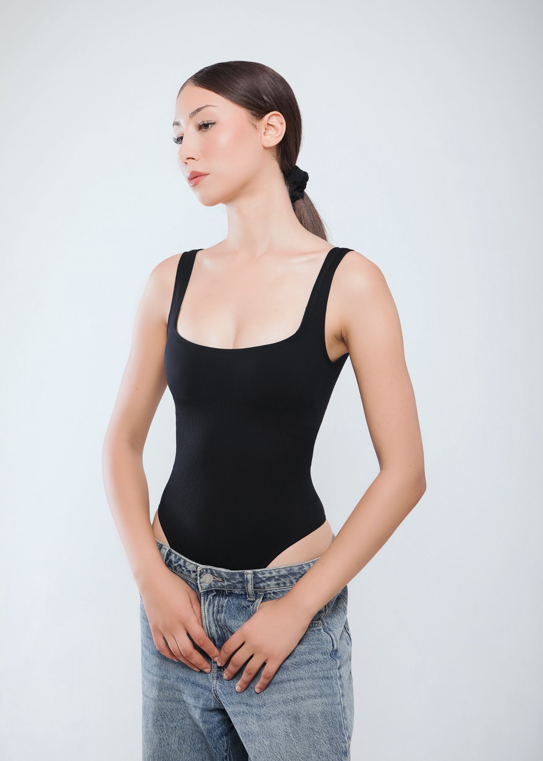 Second Skin Sculpting Thong Bodysuit in Graphite Black, worn side view