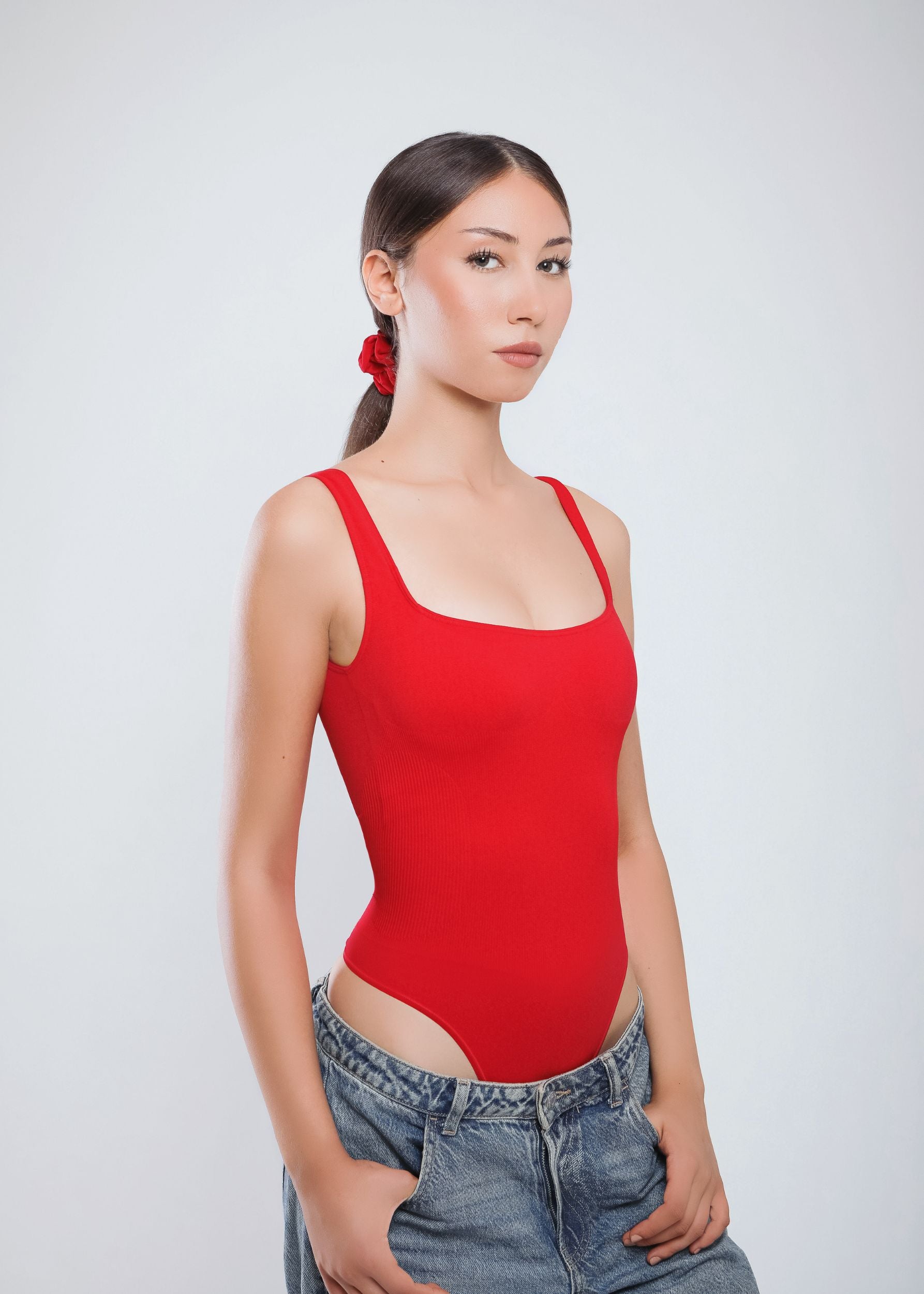 Second Skin Sculpting Thong Bodysuit in True Red, worn angled view