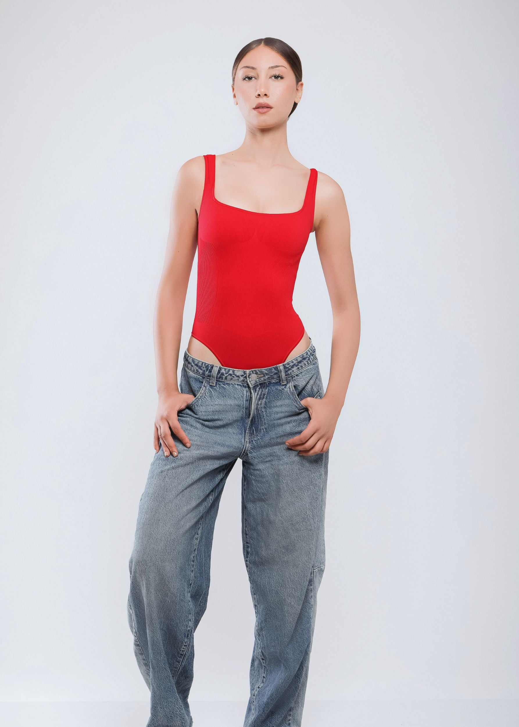 Second Skin Sculpting Thong Bodysuit in True Red, worn full-body front view